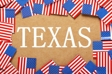 Fototapeta na wymiar The name Texas with a border of USA Flags