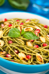 Spaghetti with pesto, pomegranate and roasted almond