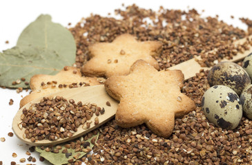 Buckwheat on a wooden spoon and egg. Photo.