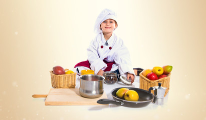 Blonde little girl dressed like chef