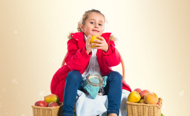 Blonde little girl holding an apple