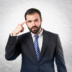 Businessman making a crazy gesture over white background
