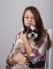 girl in a chair with a dog