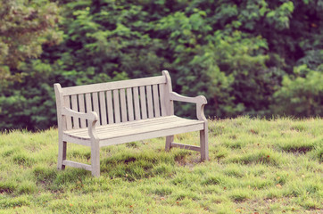 Wooden bench in the park with vintage style.