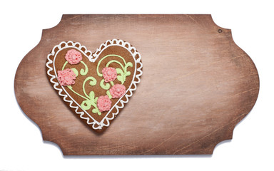 Ginger biscuits in the form of heart on a wooden  shaped board