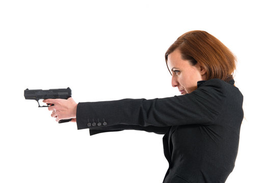 Business woman shooting with a pistol