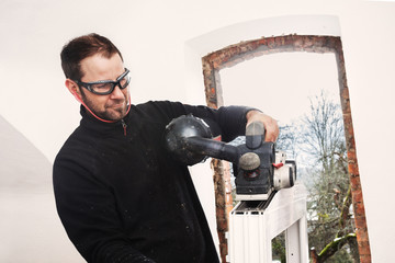 Carpenter mounting a new window