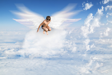 Fototapeta na wymiar boy with Angel Wings flying around in the sky