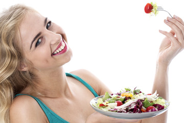 Model Released. Attractive Happy Young Woman Eating Salad