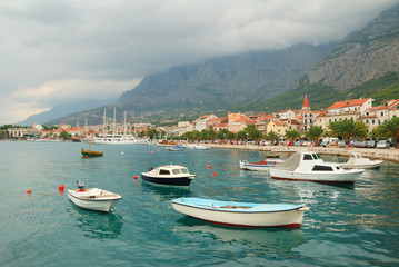 Fototapeta na wymiar Makarska town harbor with small boats in Croatia