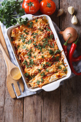 Mexican enchilada in a baking dish vertical top view