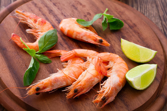 Delicious fresh seafood shrimp with lime on wooden table