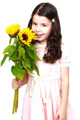 Charming long-haired girl smelling a beautiful flower.