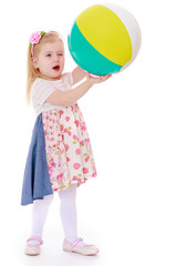 Beautiful girl holding a large inflatable ball.