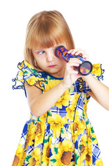 enthusiastic little girl looking into a kaleidoscope.