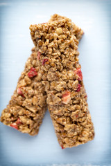 Muesli bars, cereal bars on the wooden background.
