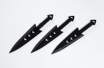 Throwing knives on a white background