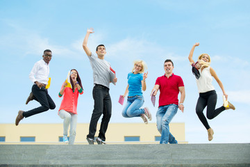 group of happy students enjoying outdoors