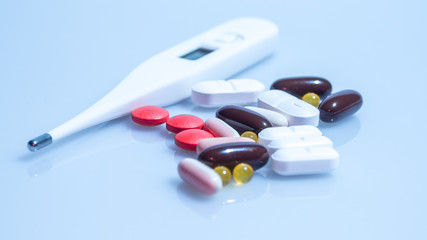 Medicine Pills and Thermometer