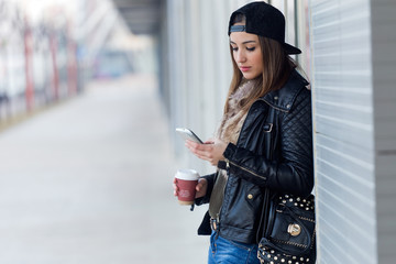 Young beautiful woman with mobile phone and coffee.