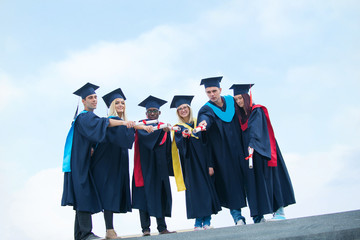 group of graduates celebrating outdoors