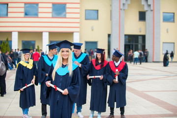 group of graduates celebrating outdoors