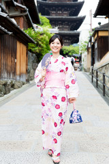 Fototapeta na wymiar young asian woman wearing kimono walking