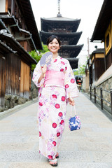 Fototapeta na wymiar young asian woman wearing kimono walking