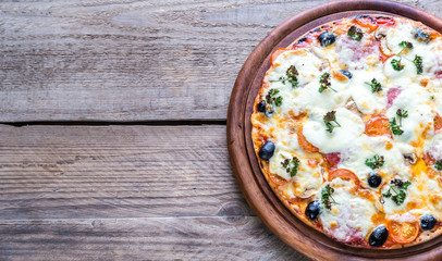 Cooked pizza on the wooden board