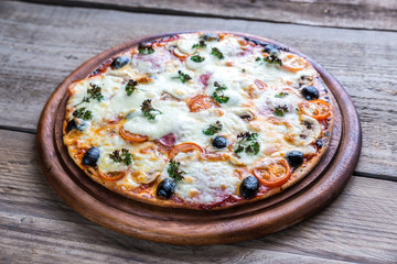Cooked pizza on the wooden board