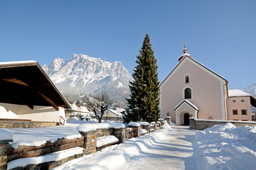 Parish church Ehrwald with Zugspitze, Germany's highest mountain