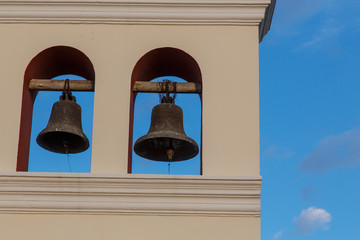 Obraz premium two bells from church with sky at background