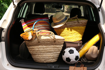 Suitcases and bags in trunk of car ready to depart for holidays