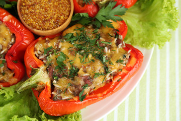 Stuffed red peppers on plate on napkin close up