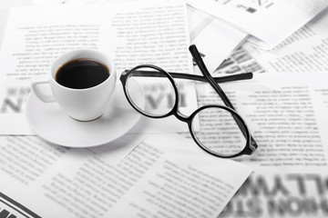 Glasses and newspapers, close-up
