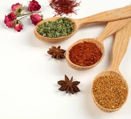 Fotobehang Verschillende specerijen en kruiden in houten lepels geïsoleerd op wit © Africa Studio