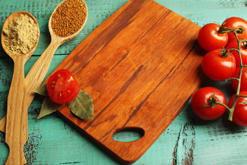Different spices and herbs with cutting board