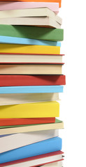 Vertical border tall stack pile of colorful books isolated white background photo