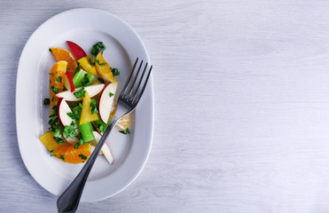 Waldorf salad with orange on plate on table close up