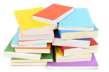 Untidy stack or pile of colorful paperback books isolated white background photo