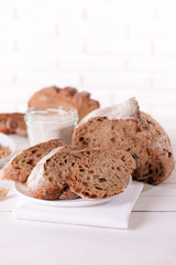 Tasty bread on table on light background