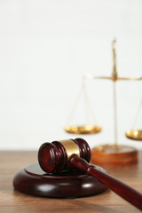 Wooden judges gavel on wooden table, close up