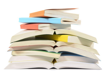 Untidy stack or pile of colorful paperback books isolated white background photo