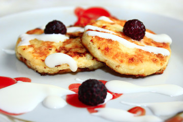 cheese cakes on the plate with raspberry