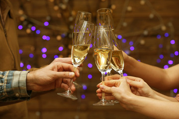 Clinking glasses of champagne in hands