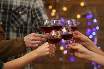 Clinking glasses of red wine in hands