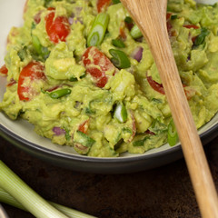 Guacamole with green onions and nachos. Selective focus.