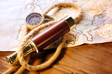 Marine still life spyglass, compass, rope and world map