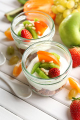 Healthy dessert with muesli and fruits on table