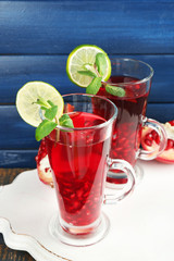 Pomegranate drink in glasses with mint and slices of lime
